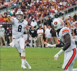  ?? Bob Levey Getty Images ?? JARRETT STIDHAM, a onetime Texas A&M recruit, throws a two-yard touchdown to Kerryon Johnson in leading Auburn to a 42-27 win Saturday.