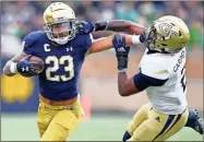  ?? Matt Cashore/usa Today sports ?? Notre Dame Fighting Irish running back Kyren Williams (23) stiff arms Georgia Tech Yellow Jackets safey Tariq Carpenter (2) in the second quarter at Notre Dame Stadium.