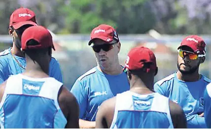  ??  ?? West Indies head coach Stuart Law (third left) chats with his players during a recent training session.