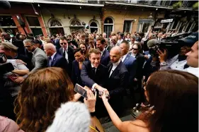 ?? (AP Photo/Gerald Herbert) ?? French President Emmanuel Macron greets the crowd as he walks down Royal Street in the French Quarter of New Orleans, Friday, Dec. 2, 2022. Next to him is New Orleans Mayor Latoya Cantrell.