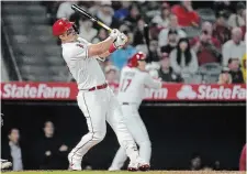  ?? ASHLEY LANDIS THE ASSOCIATED PRESS ?? Los Angeles Angels’ Mike Trout hits a home run during the eighth inning of Tuesday night’s game against the Boston Red Sox in Anaheim, Calif. The blast tied him with Joe DiMaggio for 85th in the career home runs list.