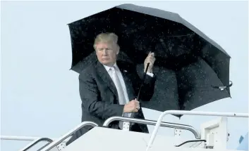  ?? ANDREW HARNIK/THE ASSOCIATED PRESS ?? U.S. President Donald Trump boards Air Force One at Palm Beach Internatio­nal Airport in West Palm Beach, Fla., on Monday. Debate over Trump’s “s---hole” comment raged in Washington on Tuesday.