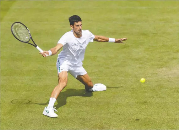  ?? SIMON BRUTY/AFP VIA GETTY IMAGES ?? Novak Djokovic takes part in a practice session at The All England Tennis Club in Wimbledon Friday ahead of the start of the 2021 tournament.