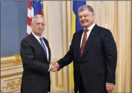  ?? LAZARENKO MYKOLA/TASS ?? U.S. Secretary of Defense James Mattis, left, and Ukraine’s President Petro Poroshenko shake hands during a meeting in Kiev on Aug. 24.