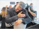  ??  ?? Ryan Pourjam, 13, son of crash victim Mansour Pourjam, is embraced by family friend Mahmoud Rastgou, after a ceremony at Carleton University.