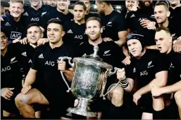  ?? MARTY MELVILLE/AFP ?? New Zealand captain Kieran Read (centre) celebrates winning the Bledisloe Cup with his players after beating Australia 29-9 at the Westpac Stadium in Wellington on Saturday.