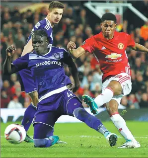  ?? ANDREW YATES / REUTERS ?? Marcus Rashford scores Manchester United’s winning goal against Anderlecht in their UEFA Europa League quarterfin­al second-leg match at Old Trafford, Manchester, on Thursday. Jose Mourinho’s side remains on course to claim the only major trophy missing...