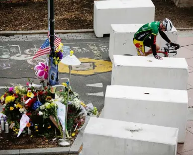  ??  ?? QUIET PRAYER: A cyclist pauses at a barricade next to the scene of last Tuesday’s attack in Manhattan by Sayfullo Saipov. Photo: Eduardo Alvarez/Getty