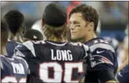  ?? BOB LEVERONE — THE ASSOCIATED PRESS ?? Tom Brady, right, talks with Chris Long, left, on the sidelines during the second half on Friday.