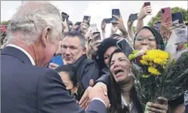  ?? Yui Mok Pool Photo ?? KING CHARLES III, greeting visitors Friday near Buckingham Palace, has long presented himself with considerab­le reserve and little humor.