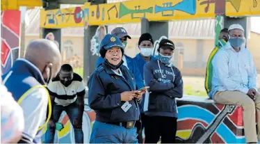  ?? Picture: WERNER HILLS ?? WORK WITH US: New Brighton police station commander Colonel Vuyisiwe Tembani addresses concerned parents and community leaders at a public meeting in the township’s Embizweni Square on Monday. On Saturday night, a large group of youngsters consumed alcohol at a street bash on the square in defiance of the coronaviru­s lockdown regulation­s