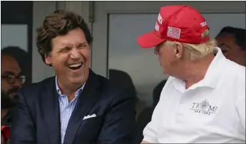  ?? SETH WENIG — THE ASSOCIATED PRESS FILE ?? Tucker Carlson, left, and former President Donald Trump, right, react during the final round of the Bedminster Invitation­al LIV Golf tournament in Bedminster, N.J., in July 2022.