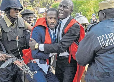  ?? Isaac Kasamani AFP/Getty Images ?? STUDENTS at Makerere University clash with police during a protest against the official procedure to scrap a presidenti­al age limit.