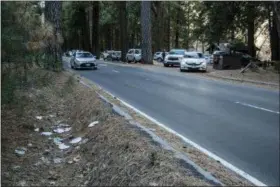  ?? DAKOTA SNIDER VIA AP ?? In this Monday photo provided by Dakota Snider shows a road lined with trash in Yosemite National Park Human feces, overflowin­g garbage, illegal off-roading and other damaging behavior in fragile areas were beginning to overwhelm some of the West’s iconic national parks on Monday, as a partial government shutdown left the areas open to visitors but with little staff on duty.