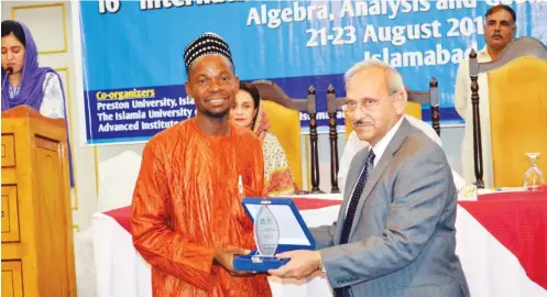  ??  ?? Hussaini Garba Mohammed of Media Trust Limited receives an award from the Vice Chancellor, Islamia University of Bahawalpur, Dr. Qaiser Mushtaq, during the 16th Internatio­nal Pure Mathematic­s Conference in Islamabad, Pakistan recently.