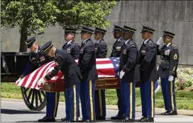  ?? JOSE LUIS MAGANA / AP ?? An Army team carries the casket of U.S. Army Air Forces 2nd Lt. Robert R. Keown to Arlington National Cemetery on Friday. Keown, who grew up near Atlanta, was piloting his P-38 aircraft when it crashed in Papua New Guinea in 1944.