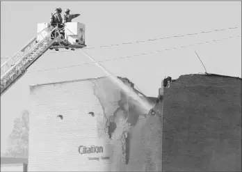  ?? ASSOCIATED PRESS PHOTO ?? Firefighte­rs try to put out a fire at Mid-Continent Airport in Wichita, Kan., Thursday.