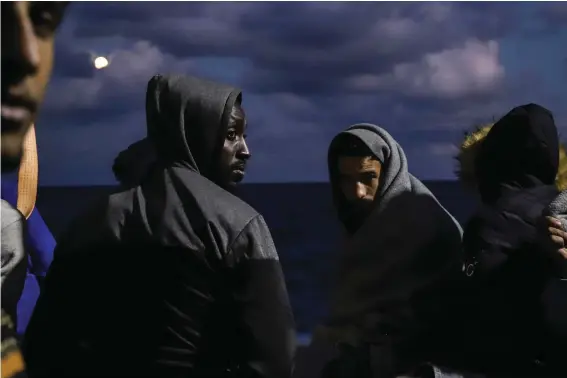  ?? ?? Migrants sit on the deck of the Sea Watch-3 rescue ship in the Maltese search and rescue zone of the Mediterran­ean Sea on Oct. 19, 2021. IEuropean Union nations will discuss on Tuesday, May 14, 2024, sweeping new reforms to the bloc's failed asylum system as campaignin­g for Europe-wide elections next month gathers pace, with migration expected to be an important issue. (AP Photo/Valeria Mongelli, File)