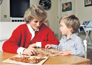  ?? ?? Candid snapshot: Princess Diana helps Prince William with a jigsaw puzzle in his playroom at Kensington Palace in 1985