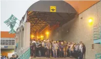  ??  ?? Crowds waiting to get into the Aug. 9 Garth Brooks concert stand under an overhang at the Brandt Centre after being asked to take cover from bad weather over Mosaic Stadium.