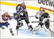  ?? Marcio Jose Sanchez Associated Press ?? KINGS GOALIE Cal Petersen stops a shot in front of Avalanche center Tyson Jost (17) at Staples Center.