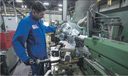  ?? FILES ?? Machinist Victor Bhachu works on a lathe at Universe Machine in Edmonton. Alberta manufactur­ing was up 1.8 per cent in June.