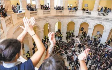  ?? Amanda Andrade-Rhoades Associated Press ?? DEMONSTRAT­ORS calling for a cease-fire in the Israel-Hamas war chant inside the U.S. Capitol in October. The coming year poses more difficulti­es for an already divided Congress that passed few bills this year.