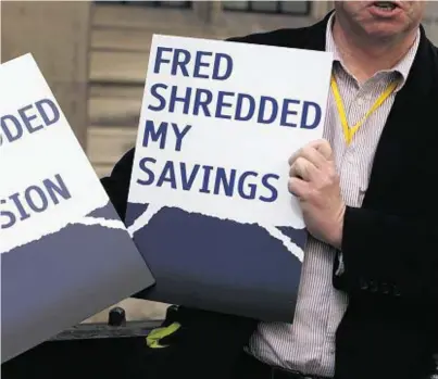  ??  ?? CLOSING IN: A man holds placards outside the Rolls Building in central London as the civil trial is adjourned