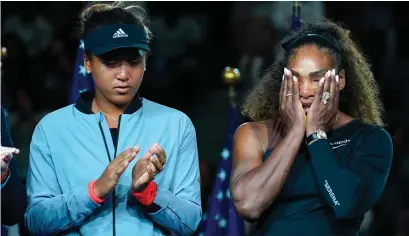  ?? GETTY ?? Naomi Osaka stands beside the defeated Serena Williams after Saturday’s night’s final. Right: Williams argues with umpire Carlos Ramos during the US Open final while Osaka, left, is pictured with her trophy at the Rockefelle­r Center yesterday