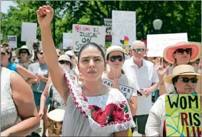  ?? JAY JANNER/AUSTIN AMERICAN-STATESMAN VIA AP ?? Maria Montelongo raises her fist at the Families Belong Together rally at the Capitol in Austin, Texas, on Saturday. Thousands gathered at the Capitol to protest family separation­s on the border.