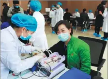  ?? SU FENG / CHINA DAILY ?? An employee of the Wuhan Blood Center donates blood on Monday in Wuhan, Hubei province, on Wednesday. Blood donation sites reopened in the city on the day.
a 26-year-old resident who donated blood after donation sites reopened in Wuhan, Hubei province, the city hit hardest by the novel coronaviru­s