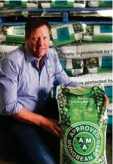  ??  ?? AMA president Mark Schmidt recommends that mungbean producers replenish their seed lines at least every three years with AMA-Approved seed, sold in these distinctiv­ely-branded bags.