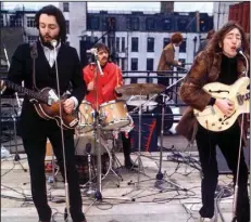  ??  ?? Beatles Paul McCartney, Ringo Starr and John Lennon perform up on the roof in Michael Lindsay-Hogg’s documentar­y “Let It Be” in 1969.