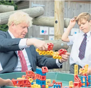  ?? Picture: PA. ?? Prime Minister Boris Johnson joined children playing with constructi­on toys during a visit to the Discovery School in Kent yesterday.
