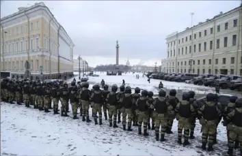  ?? Ivan Petrov/Associated Press ?? Russian Rosguardia (National Guard) soldiers stand facing the Palace Square on Saturday ahead of Sunday’s protest in St. Petersburg, Russia.