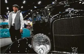  ?? Marie D. De Jesús / Staff photograph­er ?? Ruben Garcia, 70, a vintage car collector from Spring, displays his 1930s Fords at the 59th annual AutoRama on Saturday at the George R. Brown Convention Center. He has a small shop on Parker Road, where he works on his cars, like his 1932 Ford Roadster.