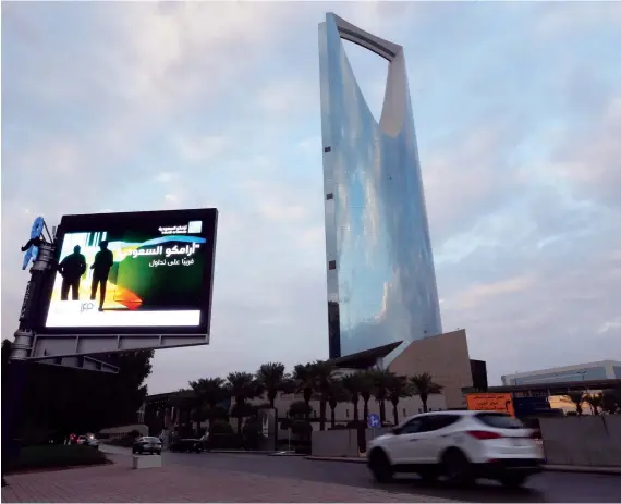  ?? Reuters ?? A billboard display an advert for Saudi Aramco in the streets in Riyadh. The oil giant is all set for a blockbuste­r initial public offering. The price range for shares has been set between SR30 to SR32.