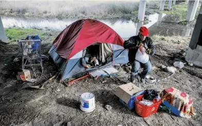  ??  ?? Army veteran Daniel Gibson lives in a tent at a homeless encampment beneath the Imhoff Drive overpass in Concord. Contra Costa County has a homeless population of about 7,500, most of them outliers living in rural encampment­s.