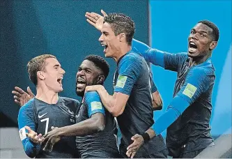  ?? MARTIN MEISSNER THE ASSOCIATED PRESS ?? France's Samuel Umtiti, second from left, is congratula­ted by Antoine Griezmann, Raphael Varane and Paul Pogba after scoring against Belgium in Tuesday’s World Cup semifinal.