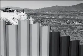  ?? ASSOCIATED PRESS ?? IN THIS JAN. 25 FILE PHOTO, an agent of the border patrol, observes near the Mexico-U.S. border fence, on the Mexican side, separating the towns of Anapra, Mexico and Sunland Park, N.M. House Republican­s are moving this week to fund President Donald...