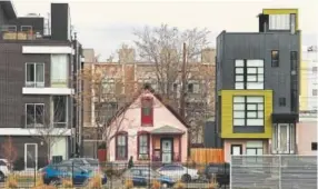  ?? RJ Sangosti, Denver Post file ?? A single-family home on Lawrence Street is sandwiched between two newer multifamil­y developmen­ts.