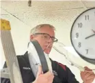  ?? ?? Chuck Minich, superinten­dent of maintenanc­e for the Richland County commission­ers, takes a look inside one of the courthouse clocks before the change to daylight saving time in March 2019.