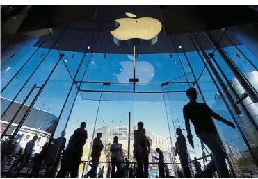  ?? Reuters ?? Missing targets: Customers walk into an Apple Store in Beijing. Apple says sales for the usually busy holiday period will likely miss analyst expectatio­ns as sales in emerging markets including India are weak.—