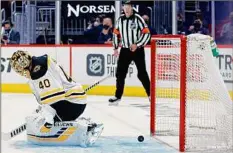  ?? Tim Nwachukwu / Getty Images ?? The puck slips past Tuukka Rask of the Bruins in overtime to give the Capitals a win in Game 1 of the Stanley Cup playoffs.