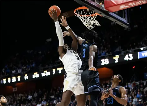  ?? Dustin Satloff/Getty Images ?? Purdue’s Brandon Newman drives to the basket as he’s defended by Villanova’s Brandon Slater in the second half of the Boilermake­rs’ 80-74 win.