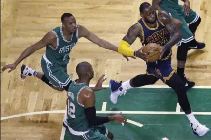  ?? CHARLES KRUPA — THE ASSOCIATED PRESS ?? LeBron James drives past Celtics guard Avery Bradley, left, and center Al Horford during the first quarter April 5 in Boston.