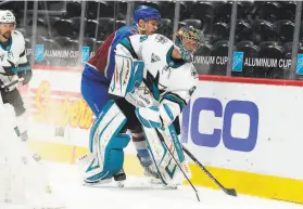  ?? David Zalubowski / Associated Press ?? Sharks goaltender Josef Korenar, who made 40 saves, clears the puck as Avalanche right wing Mikko Rantanen trails the play in the second period.