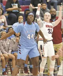  ?? / Michelle Petteys, Heritage Snapshots ?? Heritage senior Sarah Bandy shoots over Olivia Cochran of CarverColu­mbus while the Carver coaches and bench watch from the sidelines. Bandy had a game-high 16 points, but it was not enough as the visiting Lady Tigers claimed the Class 4A Elite Eight matchup, ending the Lady Generals’ season.