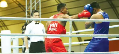  ??  ?? MEN’S MIDDLEWEIG­HT. The Philippine­s’ Eumir Marcial (in red) throws a right hook at his opponent Mohd Azwan Che Azmi of Malaysia in their middleweig­ht semifinals match for the 2019 SEA Games held at the Philippine Internatio­nal Convention Center Forum in Pasay City on Friday (Dec. 6, 2019). Marcial needed less than two minutes to advance to the finals, earning the referee’s stoppage victory over Azmi in the men’s middleweig­ht boxing. PNA photo by Jess M. Escaros Jr.