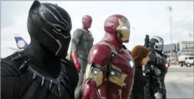  ?? THE ASSOCIATED PRESS ?? This file image provided by Disney shows, from left, Chadwick Boseman as Panther, Paul Bettany as Vision, Robert Downey Jr. as Iron Man, Scarlett Johansson as Natasha Romanoff, and Don Cheadle as War Machine in a scene from “Marvel’s Captain America:...